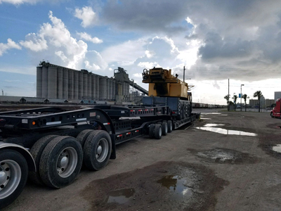 Export Logistics & Shipping, Inc. transports Liebherr LTM1100 crane by flat rack